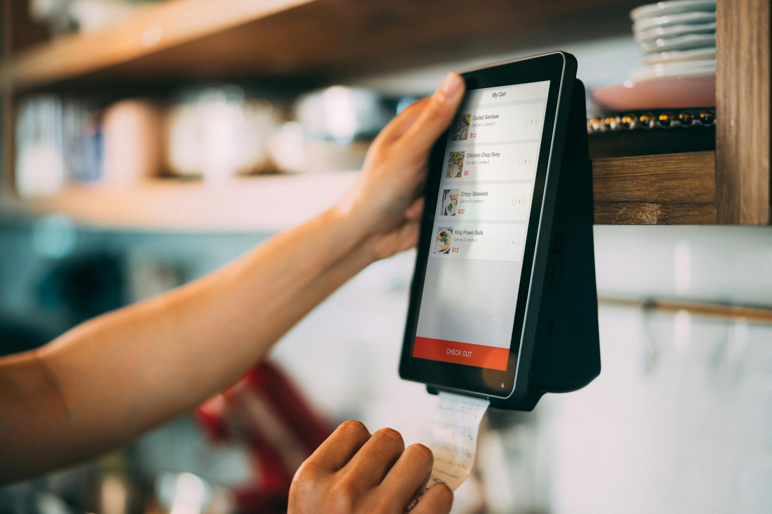 Person Holding a Payment Digital Device (scanning and converting receipts)